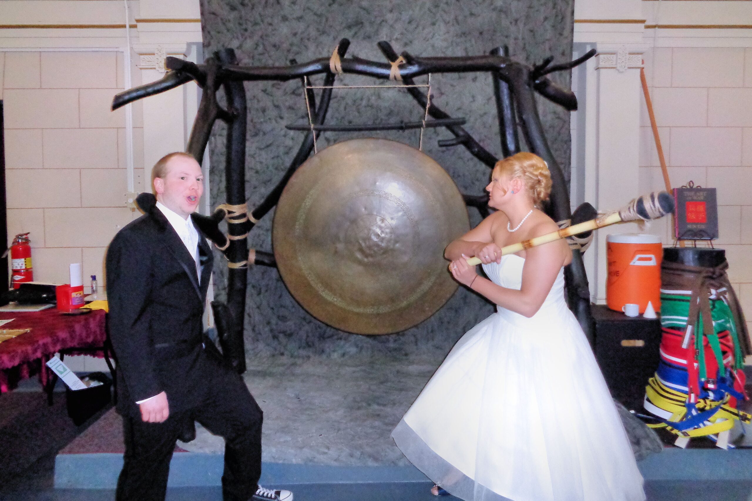 Bride and groom hitting a gong