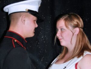 A Marine in uniform and a woman looking at each other.